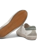 Sneakers Golden Goose et glissade