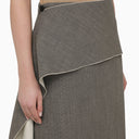 La jupe en laine blanche / noire avec train latéral