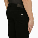 Jeans magri amiri neri con toppe mimetiche